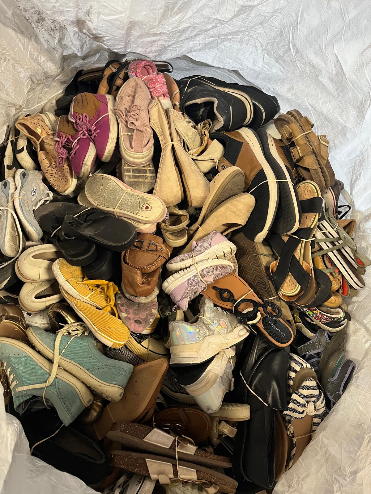 Bag of assorted used shoes and sandals