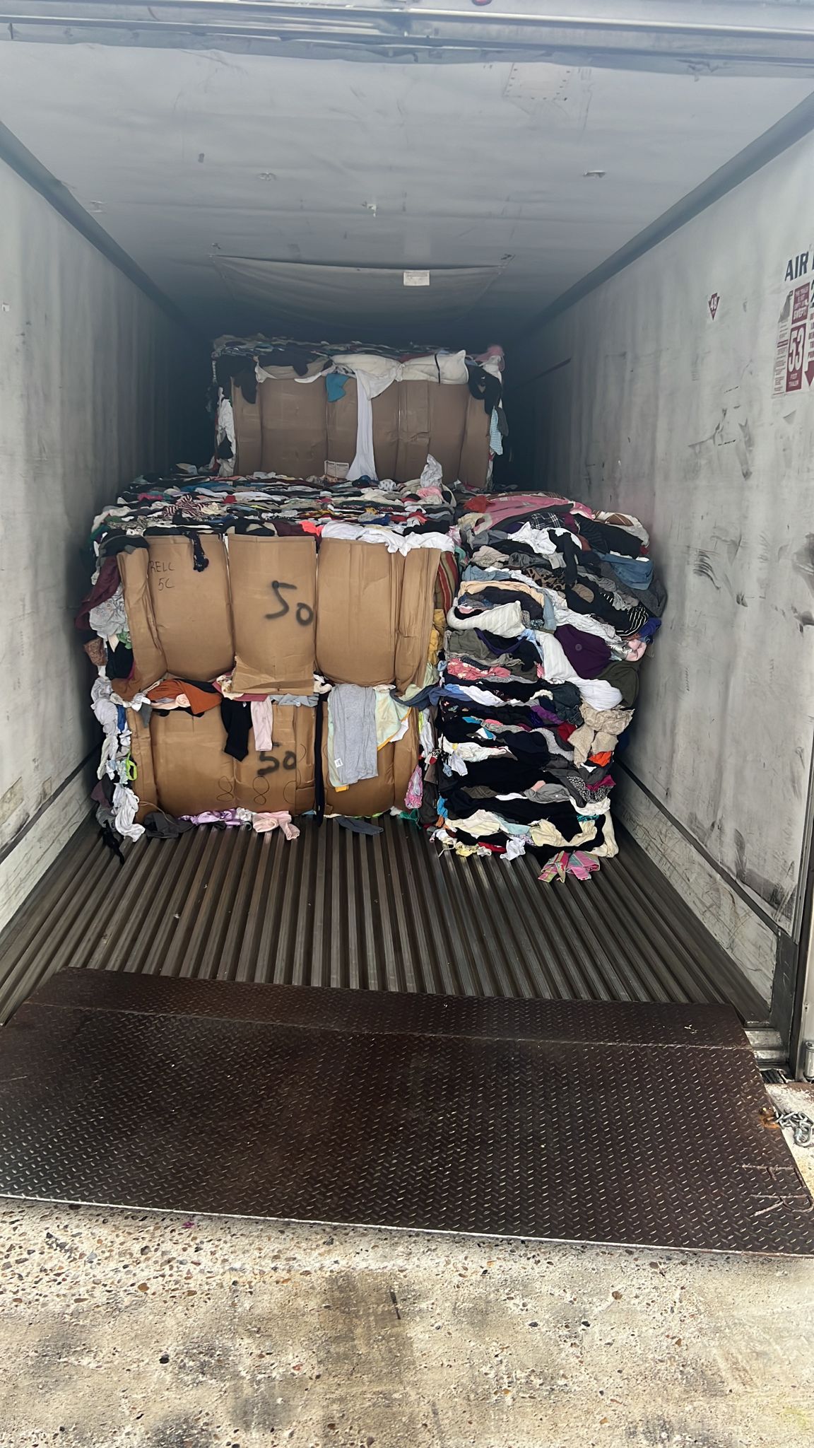 Container being loaded with bales