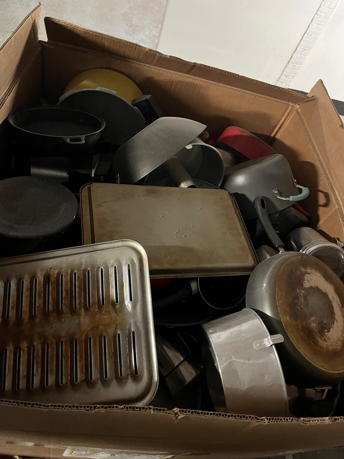 Boxes of used cookware and bakeware