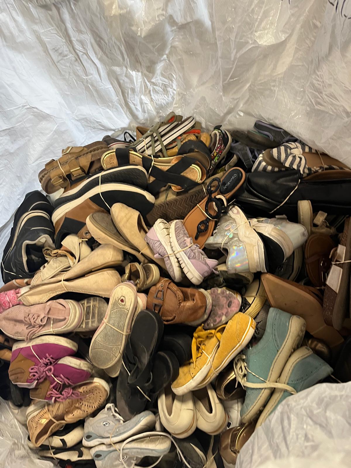 Bag of assorted used shoes and sandals